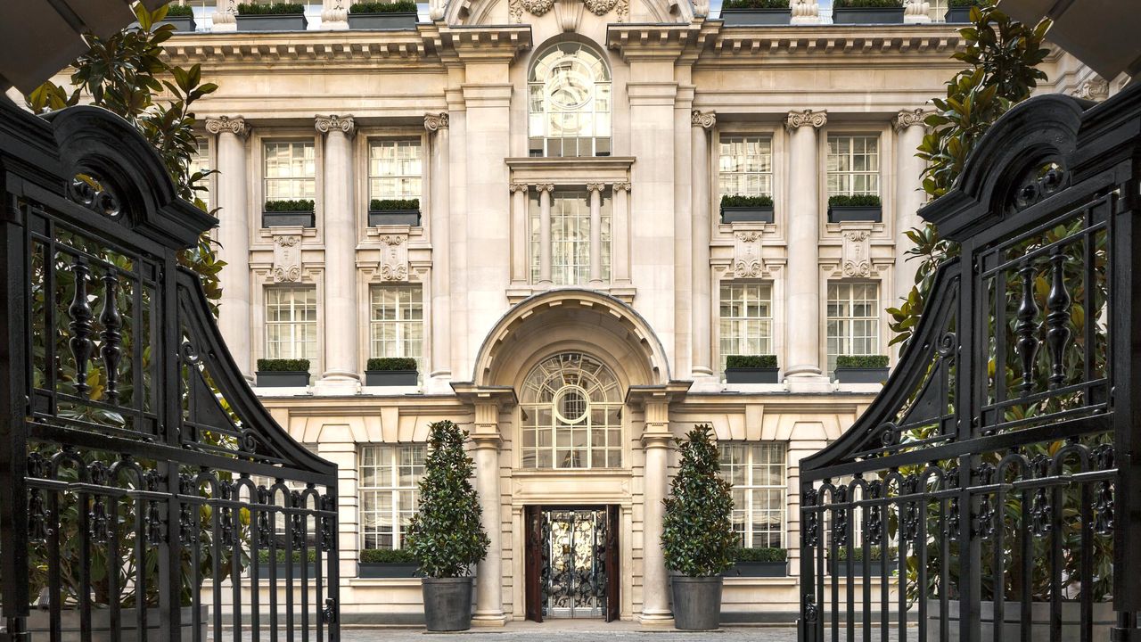 Elegant London townhouse entrance with wrought iron gates in Mayfair, symbolizing the luxury property market under pressure