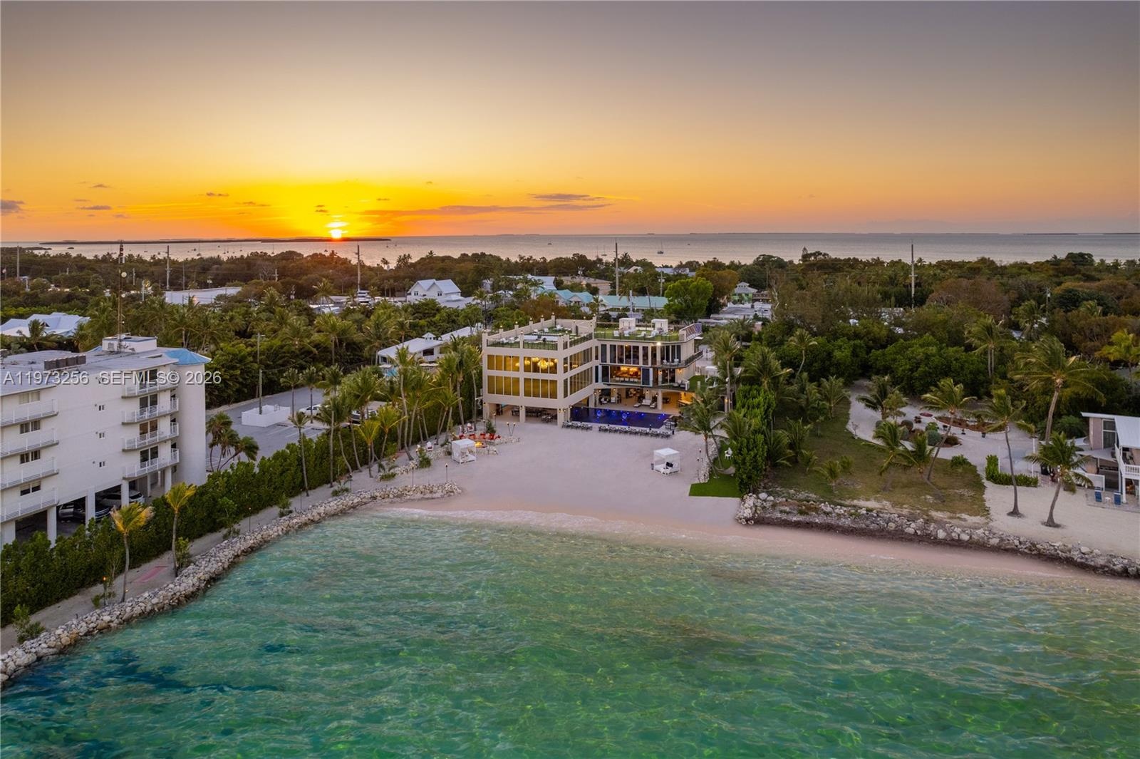 Dramatic sunset aerial view of The Chateau on the Ocean estate with rooftop terrace overlooking the Atlantic