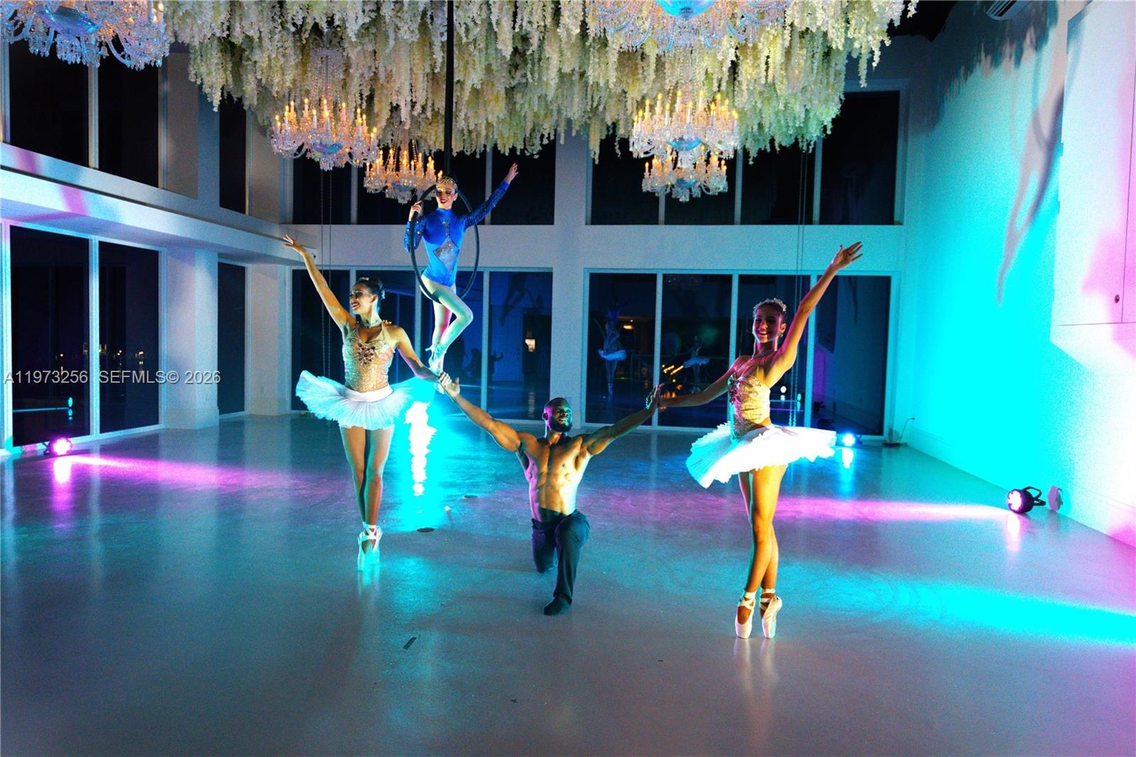 Grand entertainment area with large projection screen and Baccarat crystal chandeliers during a live performance